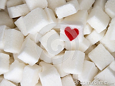 Sugar cubes with a red heart on one of them. Top view. Diet unhealty sweet addiction concept Stock Photo