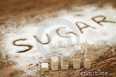 Sugar cubes and word sugar on wooden background, high sugar level and diabetes concept Stock Photo