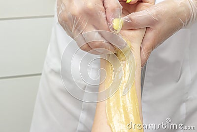 Sugar depilation shugaring hands make girl in spa center Stock Photo