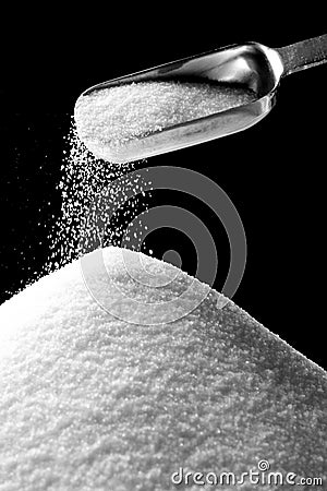 Sugar Falling from Tablespoon Stock Photo