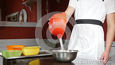 Sugar falls on a plate of apricots on a wood table Stock Photo