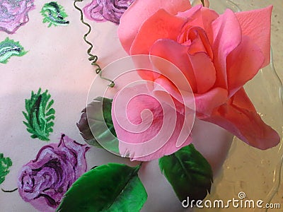 Sugar flowers, fondant pink rose on painted cake Stock Photo