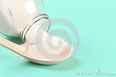 Sugar glass can with spoon on menthol background Stock Photo