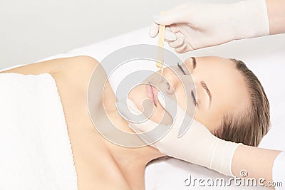 Sugar hair removal from woman body. Wax epilation spa procedure. Procedure beautician female. Mustache Stock Photo