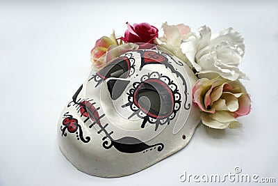 Sugar skull mask with flowers used for celebrating Day of the Dead in hispanic culture Stock Photo