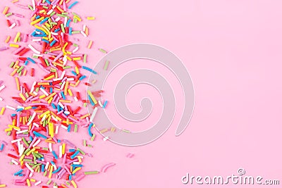Sugar sprinkle dots hearts, decoration for cake and bakery, as a background. Isolated on pink. Stock Photo