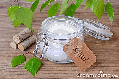 Sugar substitute xylitol, a glass jar with birch sugar, liefs and wood Stock Photo