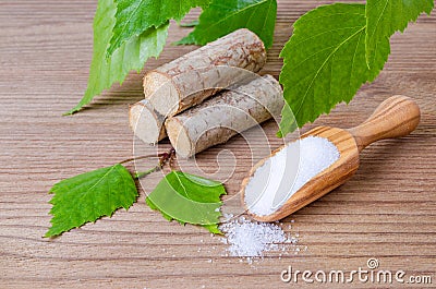 Sugar substitute xylitol, scoop with birch sugar, liefs and wood Stock Photo