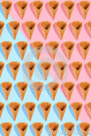 Sugar waffle cone for ice cream arranged in pattern on pink and mint background. The image with copy space can be used Stock Photo