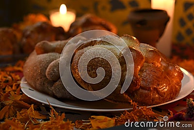 Sugary and traditional bread of the dead, celebrating dia de muertos with cempasuchilt flowers Stock Photo