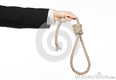 Suicide and business topic: Hand of a businessman in a black jacket holding a loop of rope for hanging on white isolated Stock Photo