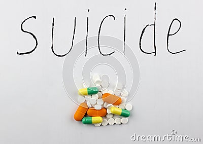 A suicide handful of pills on a white background suicide Stock Photo