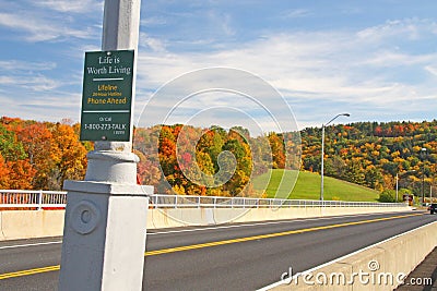 Suicide prevention phone sign on bridge in Fall Editorial Stock Photo