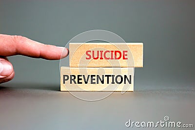 Suicide prevention symbol. Concept words Suicide prevention on wooden blocks. Beautiful grey table grey background. Psychologist Stock Photo