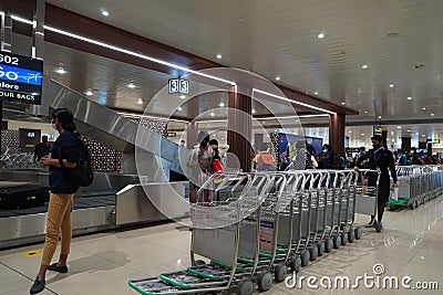 Suitcases or baggage on luggage conveyor belt in arrivals lounge of airport terminal. Selective focus. Luggage track at an airport Editorial Stock Photo