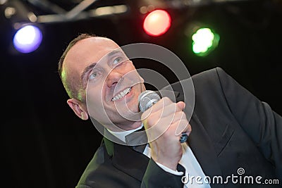 suited man performing on stage Stock Photo