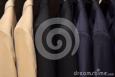 Suits on a clothing hanger. Merchandizing of clothes in a boutique. Stock Photo