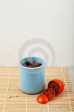 Sujeonggwa is persimmon tea. Korean fruit punch made from persimmons fruit with pine nuts Stock Photo