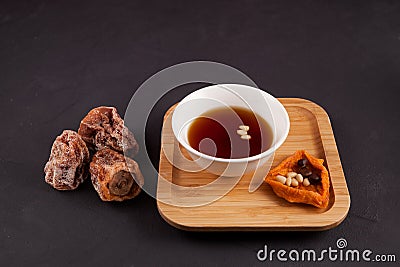 Sujeonggwa is a traditional Korean drink. Dark reddish brown in color, it is made from gotgam dried persimmon and is often Stock Photo