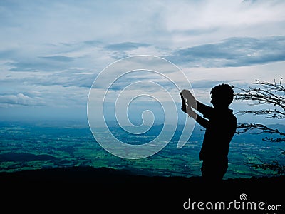 Silhouette Photo of Tourist stand on the cliff in Khao Luang mountain in Ramkhamhaeng National Park Editorial Stock Photo