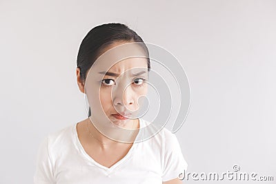 Sulk and grumpy face expression of woman in white t-shirt. Concept of offended peevish and sulky Stock Photo