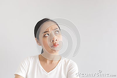 Sulk and grumpy face expression of woman in white t-shirt. Concept of offended peevish and sulky Stock Photo
