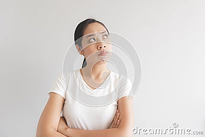 Sulk and grumpy face expression of woman in white t-shirt. Concept of offended peevish and sulky Stock Photo