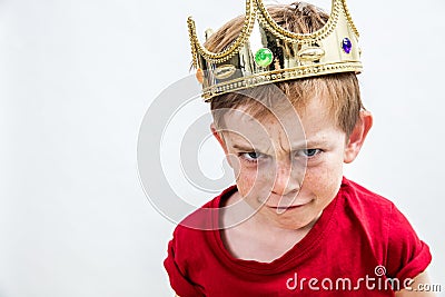 Sulking funny face of a little boy wearing a crown Stock Photo