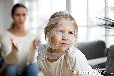 Sulky angry offended kid girl pouting ignoring mother scolding h Stock Photo