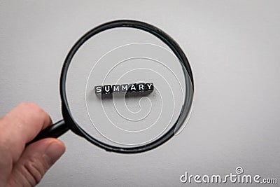 SUMMARY. Search, accounting, audit and survey concept. magnifying glass in a man& x27;s hand Stock Photo