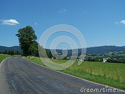 Summer asphalt road over a hill Stock Photo
