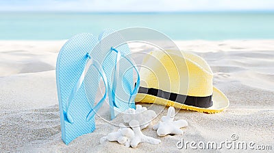 Summer background banner with flip flops. Vacation holiday accessories on beach. Slippers, hat and shell on sand near ocean. Stock Photo