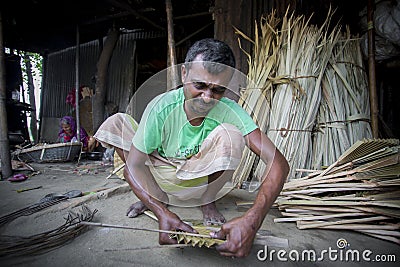 A worker is busy in making hand held fan. Editorial Stock Photo