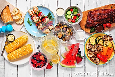 Summer BBQ or picnic food top down view table scene on a white wood background Stock Photo