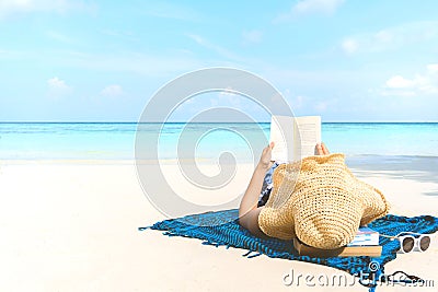 Summer Beach Holiday Woman reading a book on the beach in free time Stock Photo