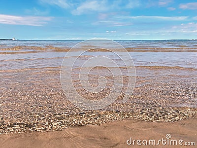 summer beach sand sea water wave sunny day blue sky white clouds at Baltic sea seascape Stock Photo