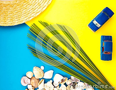 Summer Beach Travel concept. Palm Tree Leaf, straw hat, seashell, blue car on yellow background Stock Photo