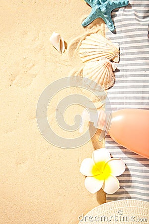 Summer beach, travel, holiday, vacation concept. Tube of sunscreen, starfish, plumeria frangipani and seashells on the Stock Photo