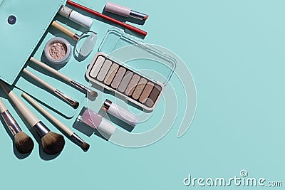 Summer beauty cosmetic products on blue background, open bag Stock Photo