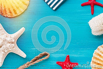 Summer board of sea shells scallop and star fish on blue wooden background Stock Photo