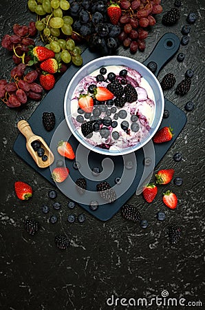 Summer breakfast with yoghurt and berries creative flatlay top view Stock Photo