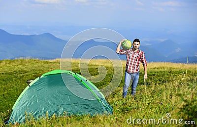 Summer camping. man hold watermelon. fruits and vitamins. mountain camping. man live in tent. hiking. mountain traveling Stock Photo