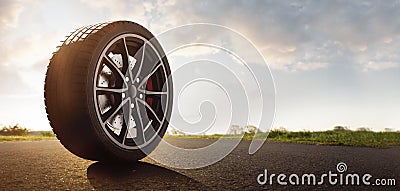 Car tires on a summer road Stock Photo