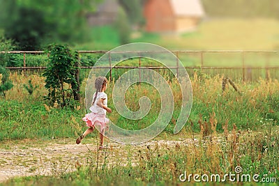 Summer, childhood, leisure and people concept - happy Cute little Girl is running on green summer park Stock Photo