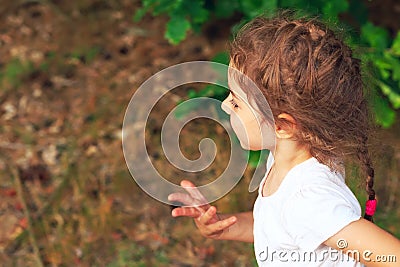 Summer, childhood, leisure and people concept - happy little Girl is running on green summer park Stock Photo