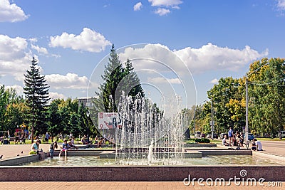 In summer, children relax in the park and bathe in the city fountain Editorial Stock Photo
