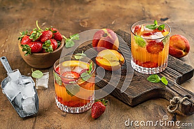 Summer cold drink fruits berries Peach strawberry ice mint leaves Stock Photo