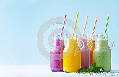 Summer colorful fruit smoothies in jars on blue background. Healthy, detox and diet food concept Stock Photo