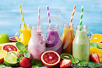 Summer colorful fruit smoothies in jars with ingredients. Healthy, detox and diet food concept Stock Photo
