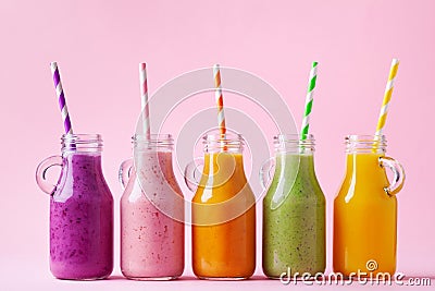 Summer colorful fruit smoothies in jars on pink background. Healthy, detox and diet food concept Stock Photo